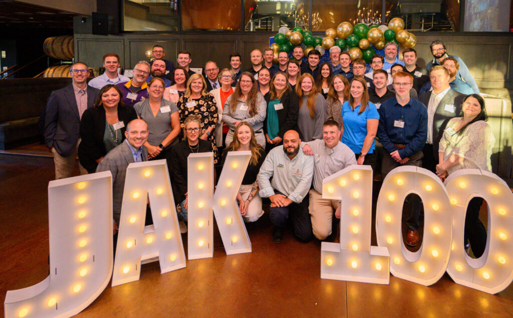 Team photo of John A. Knutson & Co., PLLP celebrating 100-year anniversary, featured in outsourced marketing retainer case study.